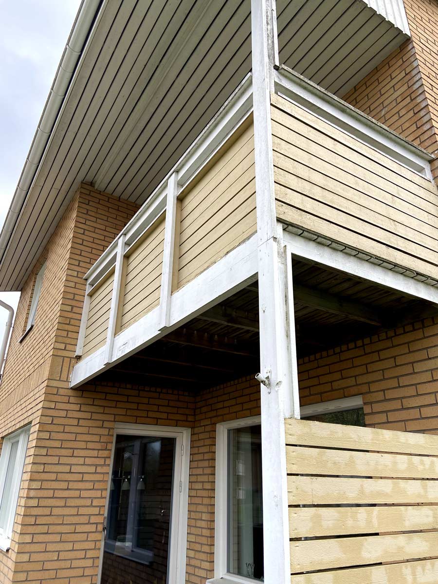 Ny balkong med vitt räcke och mörkt trädäck i Värnamo, byggd av AF Byggservice